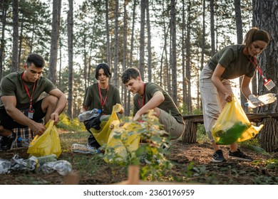 group of teenage friends gen Z male and female caucasian men women picking up waste garbage plastic bottles and paper from the forest cleaning up nature in sunny day environmental care ecology concept - Powered by Shutterstock