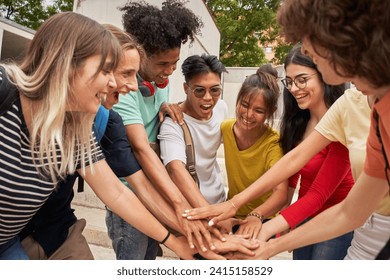 Group of teenage friends high-fiving each other, happy and motivated, having a good time together. Concept of friendship and youth. - Powered by Shutterstock