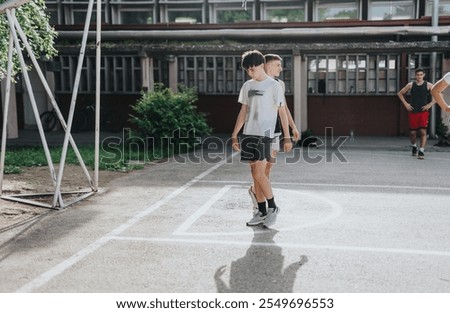 Similar – Young man riding on skate and holding surfboard