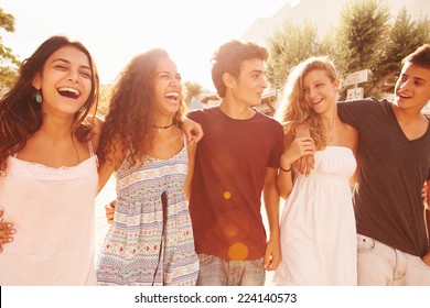 Group Of Teenage Friends Walking Along Street