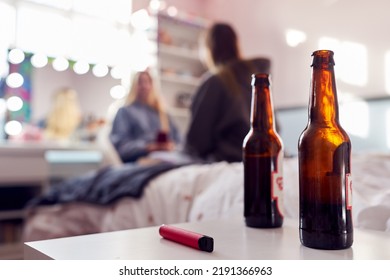 Group Of Teenage Girls In Bedroom With Bottles Of Beer And Vape Pen In Foreground