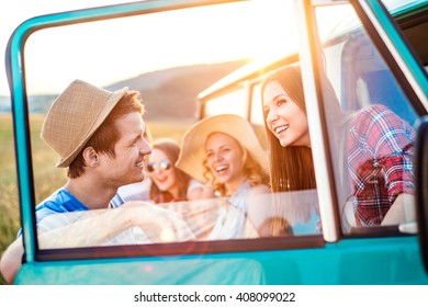 Group Of Teenage Hipsters On A Roadtrip, Campervan