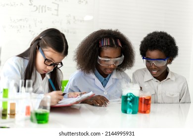 Group of teenage student learn science and study doing a chemical science experiment and holding test tube in hand in the experiment laboratory class on table at school.Education