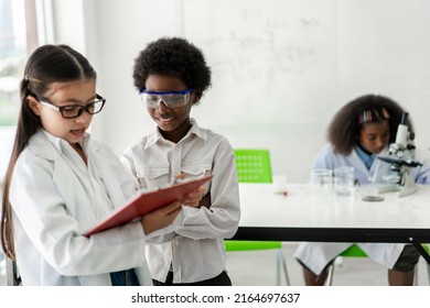 Group of teenage student learn science with teacher and study doing a chemical science experiment and holding test tube in hand in the experiment laboratory class on table at school.Education