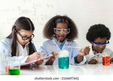 Group of teenage student learn science with teacher and study doing a chemical science experiment and holding test tube in hand in the experiment laboratory class on table at school.Education