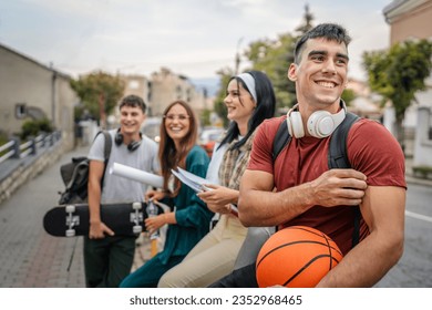 group of teenage students gen z in front of school university male and female friends caucasian man and woman teenagers in front of campus or wait for the class back to school concept - Powered by Shutterstock