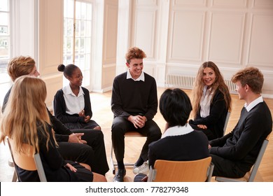 Group Of Teenage Students Having Discussion In Class Together