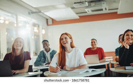 Group Of Teenage Students Smiling During The Lecture In Classroom. University Students Laughing In Classroom.