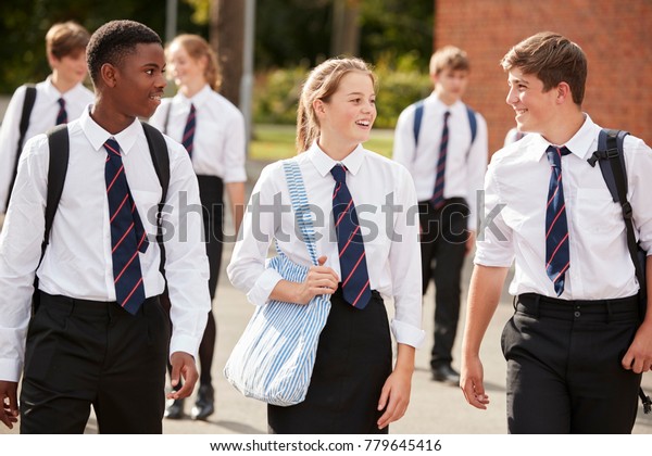 Group Of Teenage Students In Uniform Outside
School Buildings