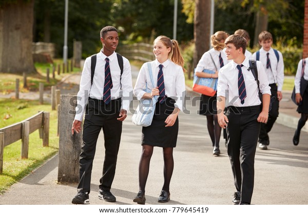 Group Of Teenage Students In Uniform Outside\
School Buildings