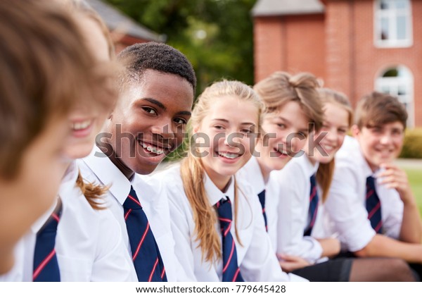 Group Of Teenage Students In Uniform Outside
School Buildings