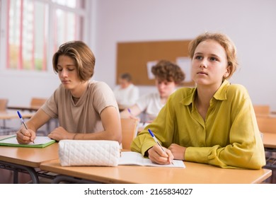 Group Of Teenage Students Working At Class, Listening Explanations Of Teacher In Classroom