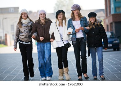 A Group Of Teenage Walking Towards The Camera