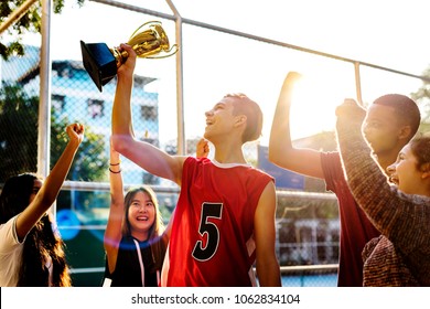 Group of teenagers cheering with trophy victory and teamwork concept - Powered by Shutterstock