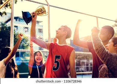 Group of teenagers cheering with trophy victory and teamwork concept - Powered by Shutterstock