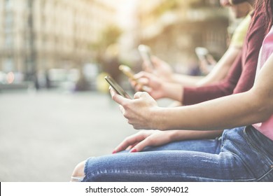 Group Of Teenagers Friends Watching Mobile Phones In City - Young People Addiction To Technology Trends - Alienation Moment For New Generation Problem - Focus On First Hand - Warm Cinematic Filter