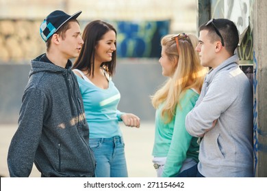 Group Of Teenagers Hanging Out In The Skate Park Or Schoolyard