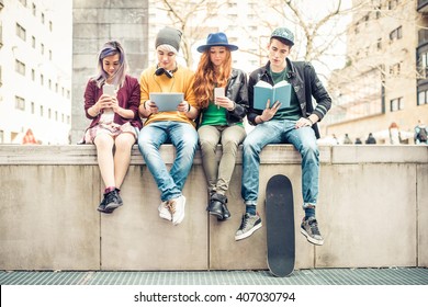 Group Of Teenagers Making Different Activities Sitting In An Urban Area - Friends Hanging Out Outdoors