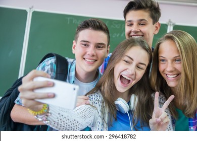 Group Of Teenagers Making Fun Selfie In Classroom