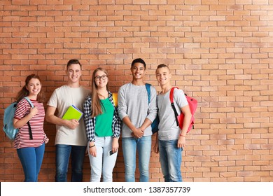 Group of teenagers near brick wall - Shutterstock ID 1387357739