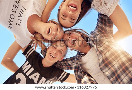 Similar – Young people with their heads together having fun