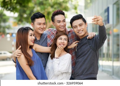 Group Of Teenagers Taking Selfie Together Outdoors