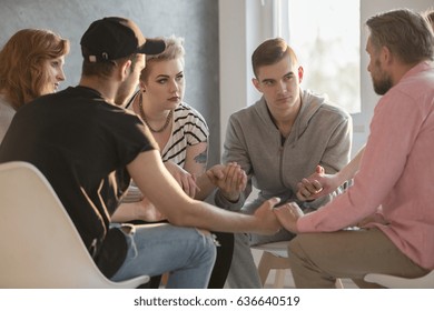 Group of teenagers talking with addiction counselor