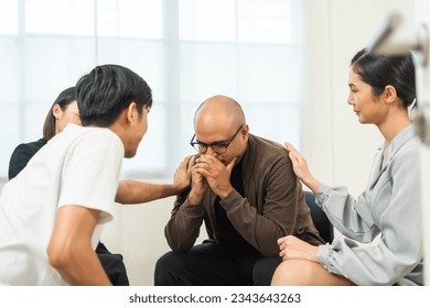 Group therapy session. Crying asian man feel pain upset depression talk about problems in life. Get psychological support of counselor diverse people friend group help motivation. - Powered by Shutterstock