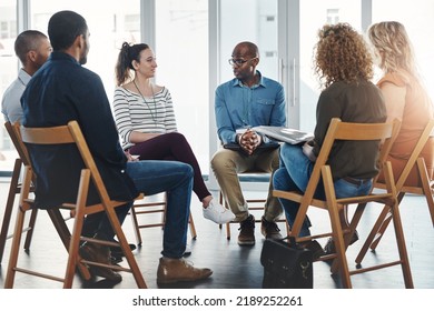 A group therapy session with diverse people sharing their sad problems and stories. People sitting in a circle talking about their mental health issues and looking for support, help and counseling