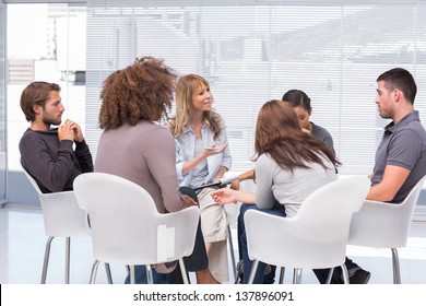 Group therapy session sitting in a circle - Powered by Shutterstock