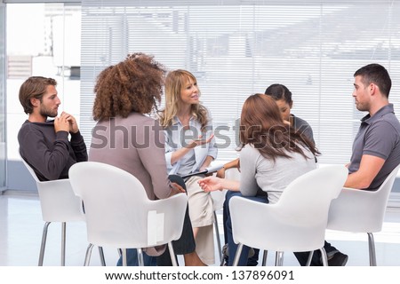 Group therapy session sitting in a circle
