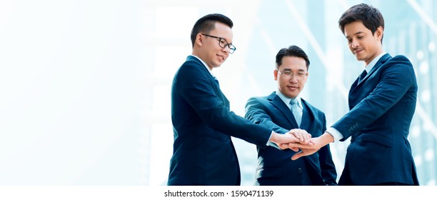 Group Of Three Asian Businessmen Put Their Hands On Wear A Blue Suit Teamwork For Success Honesty Of Work The Merger Agreement Of The Company Integrity In Development Of The Organization To Progress