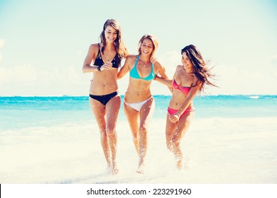 Group of Three Beautiful Attractive Young Women Walking on the Beach