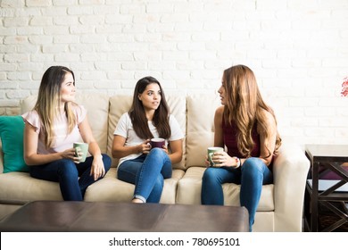 Group Of Three Female Friends Talking About Something Serious While Drinking Some Coffee