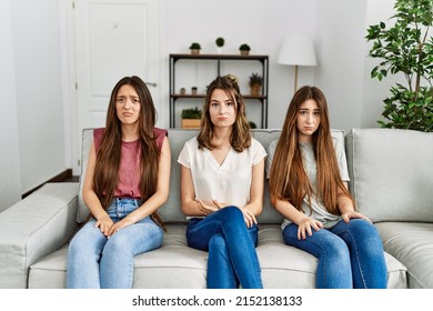 Group Of Three Hispanic Girls Sitting On The Sofa At Home Depressed And Worry For Distress, Crying Angry And Afraid. Sad Expression. 