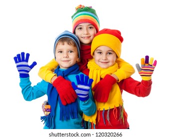 Group of three kids in bright winter clothes, isolated on white