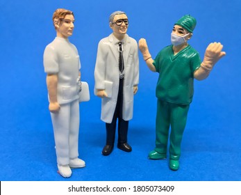Group of three medical professionals.Doctors and a surgeon are talking.Figurine of doctors and a surgeon.Medical 
concept.