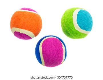 A group of three small rubber fetch balls for dogs on a white background.