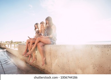 Group Of Three Woman In Friendship Taking Selfies And Using Phone Near The Beach In Tenerife. Sunset Time, Lot Of Smile And Happiness In Vacation. Beautiful Girls Enjoy The Indipendent Life