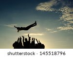Group throwing girl in the air
