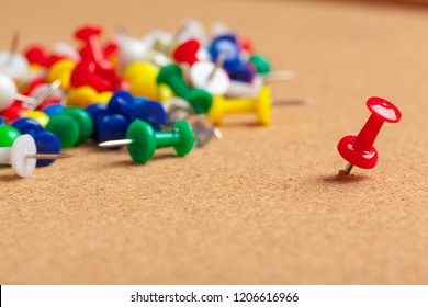 Group Of Thumbtacks Pinned On Corkboard Close Up. School Or Business Concept