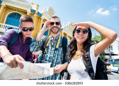 Group of tourist backpacker friends looking for direction while traveling in Bangkok Thailand on summer holidays