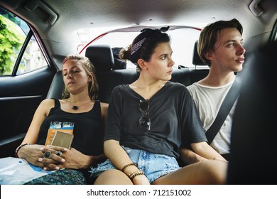 Group Of Tourist Sitting In The Taxi Backseat Doing Sight Seeing Tour