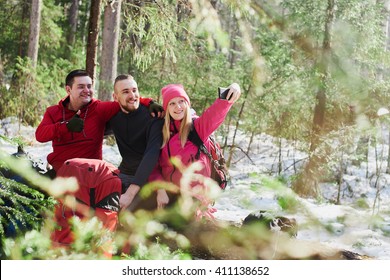 A Group Of Tourists Doing Selfies In The Woods