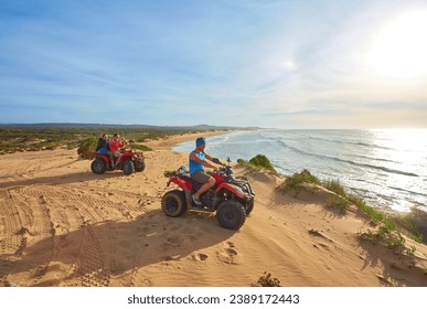 A group of tourists enjoys quad biking along Essaouira's oceanfront, creating an adventurous spectacle against the scenic coastal backdrop - Powered by Shutterstock