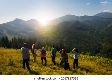 Group of tourists on hill in mountains. Drone photography - Powered by Shutterstock