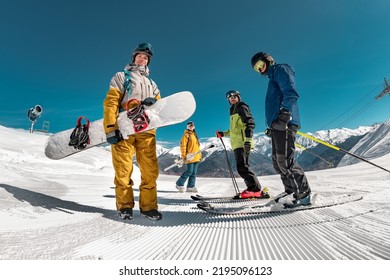 Group of tourists skiers and snowboarders stands at ski resort. Winter sports concept - Shutterstock ID 2195096123