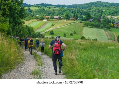 A group of tourists is walking along the tourist trail. Picturesque rural landscape. - Powered by Shutterstock