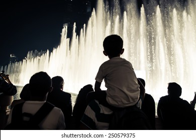 group of tourists watching fountain show