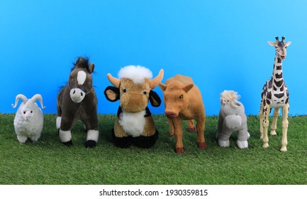 Group Of Toy Animals On Artificial Grass